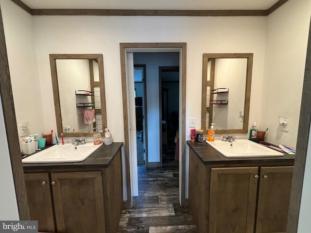 bathroom featuring vanity, crown molding, and hardwood / wood-style flooring