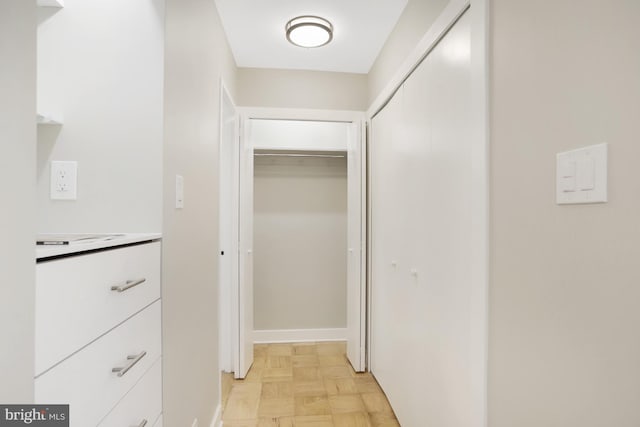 corridor with light parquet floors