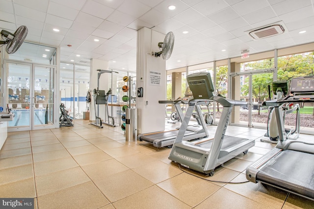 gym featuring a drop ceiling and floor to ceiling windows