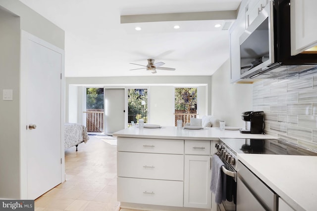 kitchen featuring stainless steel appliances, plenty of natural light, and white cabinetry