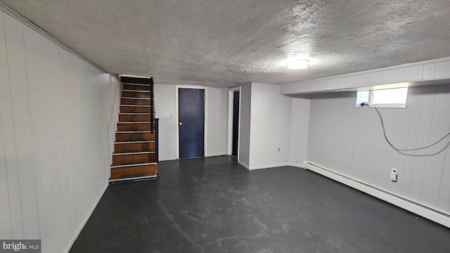 basement with a textured ceiling and a baseboard radiator