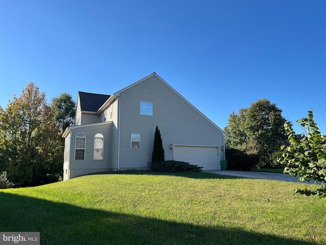 view of home's exterior featuring a garage and a yard