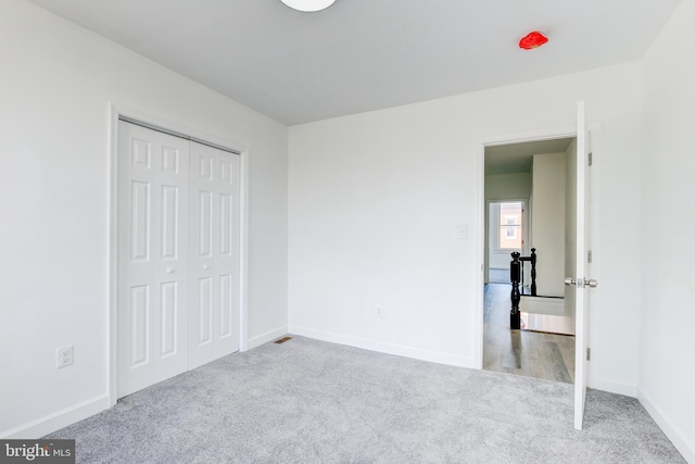 unfurnished bedroom with a closet and carpet