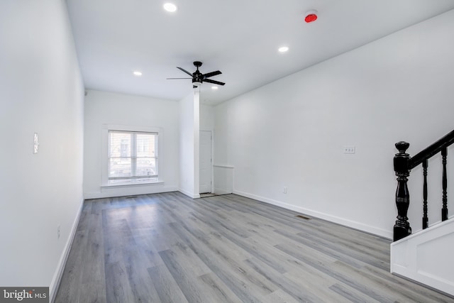 unfurnished living room with ceiling fan and light hardwood / wood-style floors