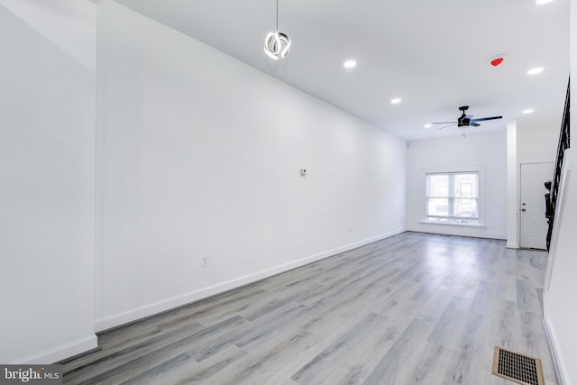 empty room featuring ceiling fan and light wood-type flooring