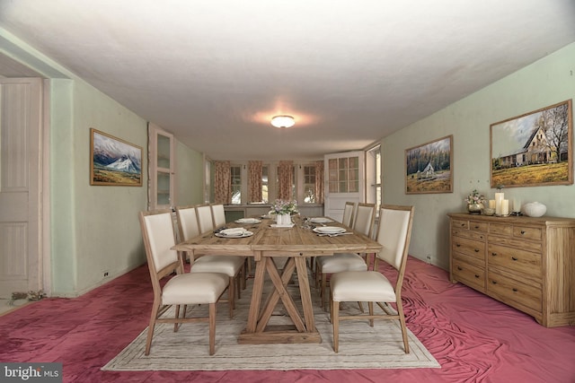 dining room with light colored carpet