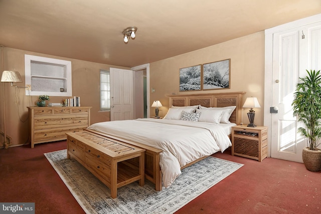 bedroom featuring dark colored carpet