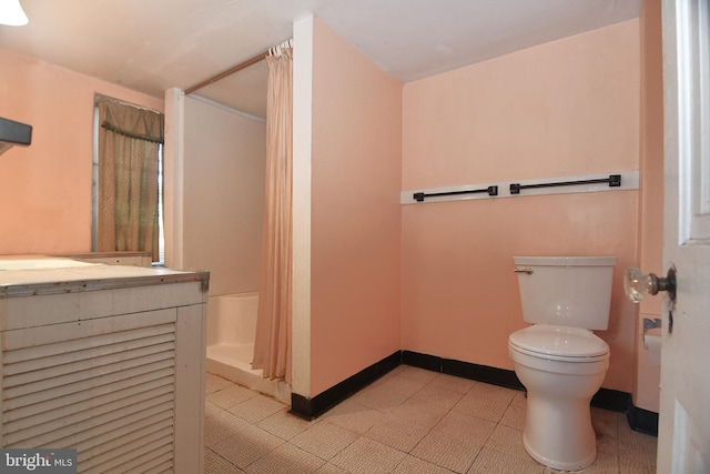 bathroom with tile patterned floors, toilet, vanity, and a shower with shower curtain