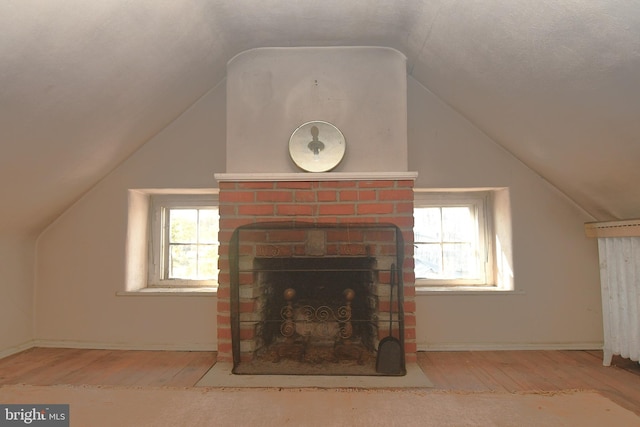 interior space featuring wood-type flooring, a textured ceiling, and a fireplace