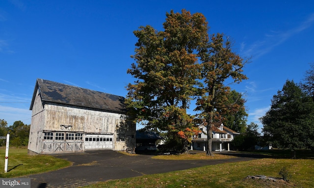 view of home's exterior with a garage and a yard