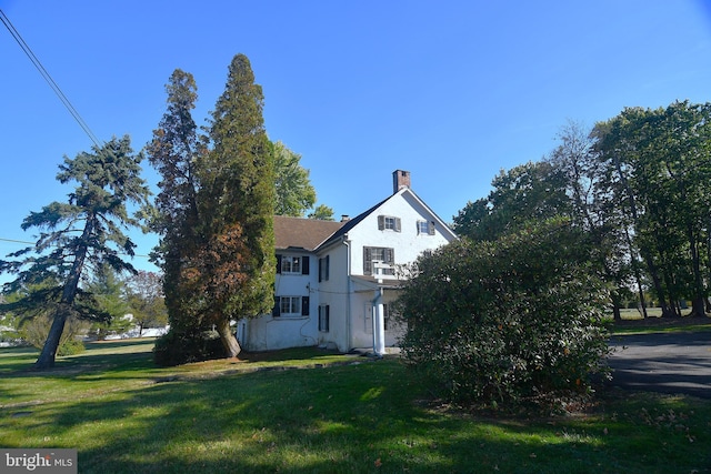 view of property exterior featuring a lawn