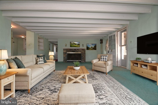 carpeted living room with beamed ceiling and a fireplace