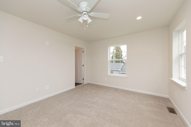 unfurnished room featuring light carpet and ceiling fan