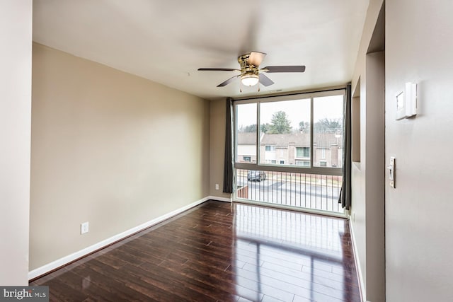 spare room featuring ceiling fan and dark hardwood / wood-style floors