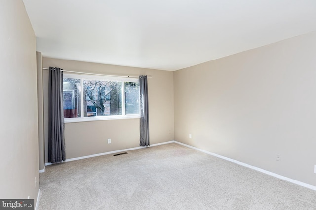 empty room featuring light carpet