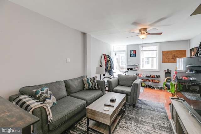 living room with ceiling fan and dark hardwood / wood-style floors