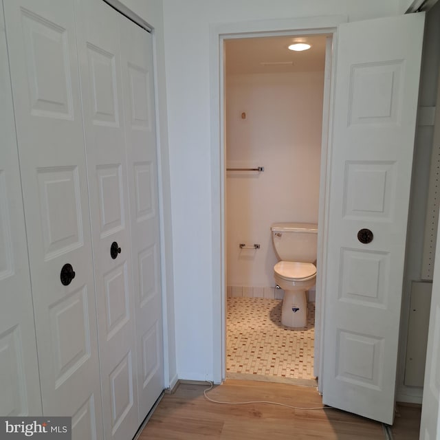 bathroom featuring hardwood / wood-style floors and toilet