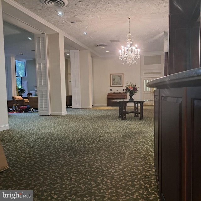 corridor featuring carpet flooring, a chandelier, and a textured ceiling