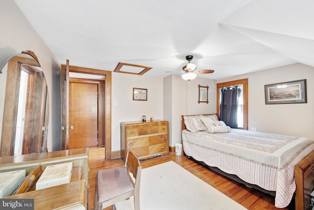 bedroom featuring light hardwood / wood-style floors, ceiling fan, and lofted ceiling