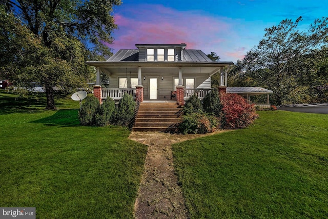 view of front of house featuring a lawn and a porch