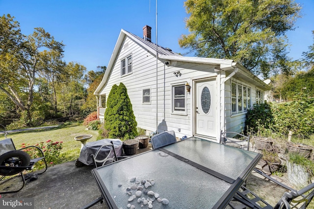 exterior space with a patio and a lawn