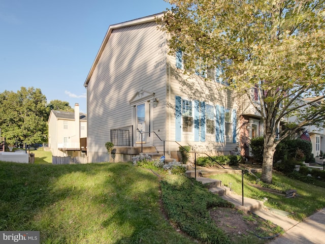 view of side of home featuring a lawn