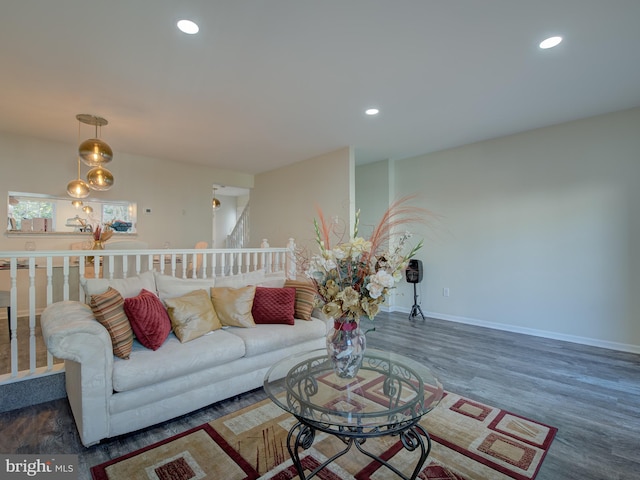 living room featuring dark hardwood / wood-style flooring and a notable chandelier