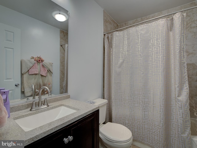 full bathroom with vanity, toilet, and shower / tub combo with curtain