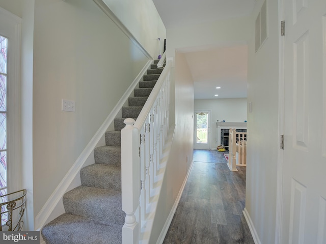 stairway with hardwood / wood-style flooring