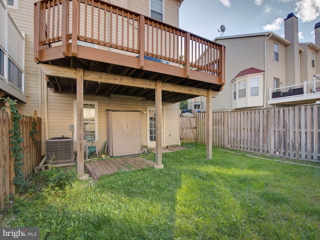 back of property featuring a lawn, a wooden deck, and central air condition unit