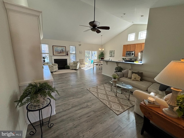 living room featuring wood-type flooring, plenty of natural light, and ceiling fan