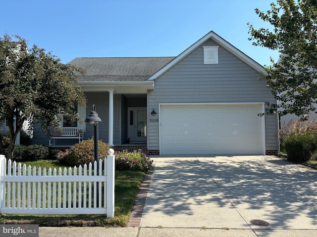 ranch-style house featuring covered porch and a garage