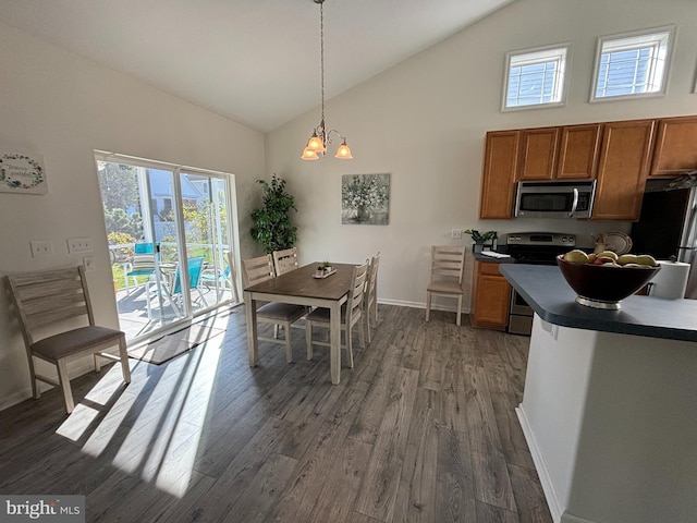 dining area featuring a notable chandelier, dark hardwood / wood-style flooring, and high vaulted ceiling