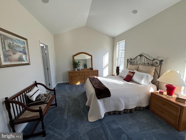 carpeted bedroom with vaulted ceiling