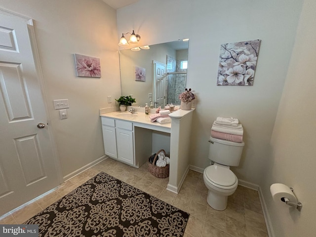 bathroom with toilet, vanity, tile patterned floors, and a shower with shower door