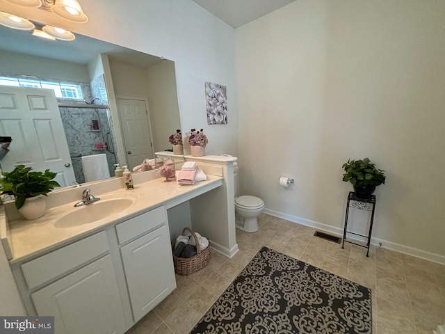 bathroom with vanity, an enclosed shower, and toilet