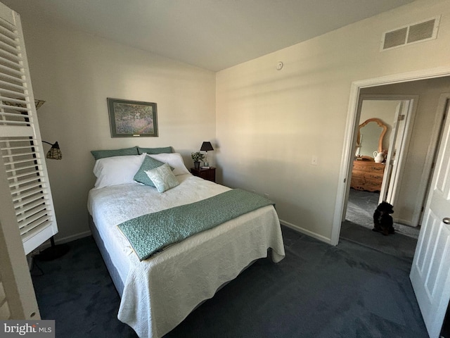 bedroom with dark colored carpet