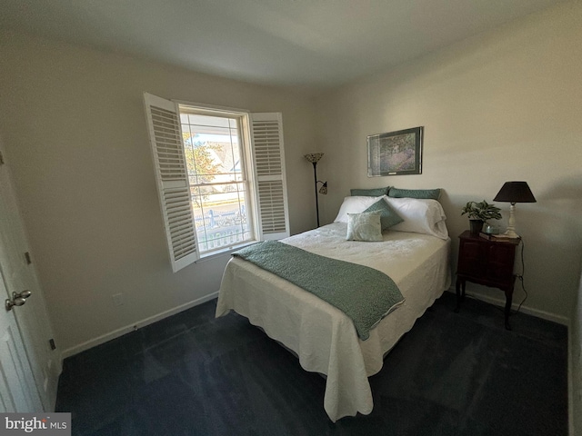 bedroom with dark colored carpet