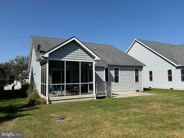 back of property featuring a lawn and a sunroom