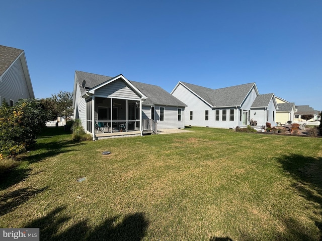 back of house featuring a sunroom and a yard