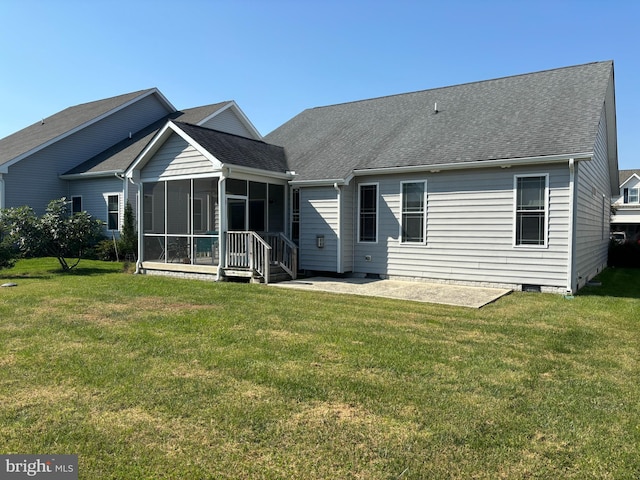 rear view of property with a yard, a patio area, and a sunroom