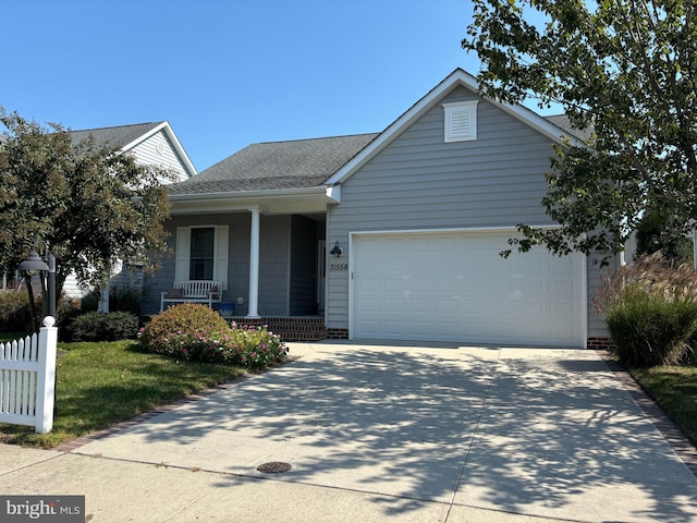 view of front of property with covered porch and a garage