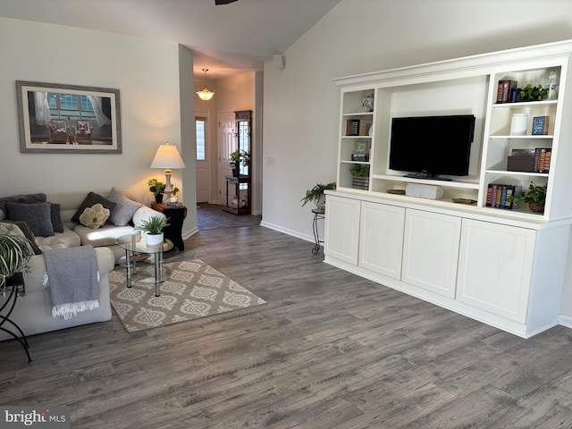 living room featuring dark hardwood / wood-style flooring, a chandelier, and lofted ceiling