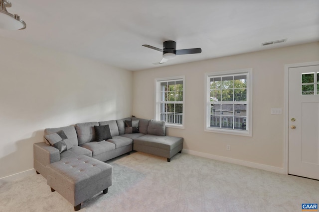 living room with light colored carpet and ceiling fan