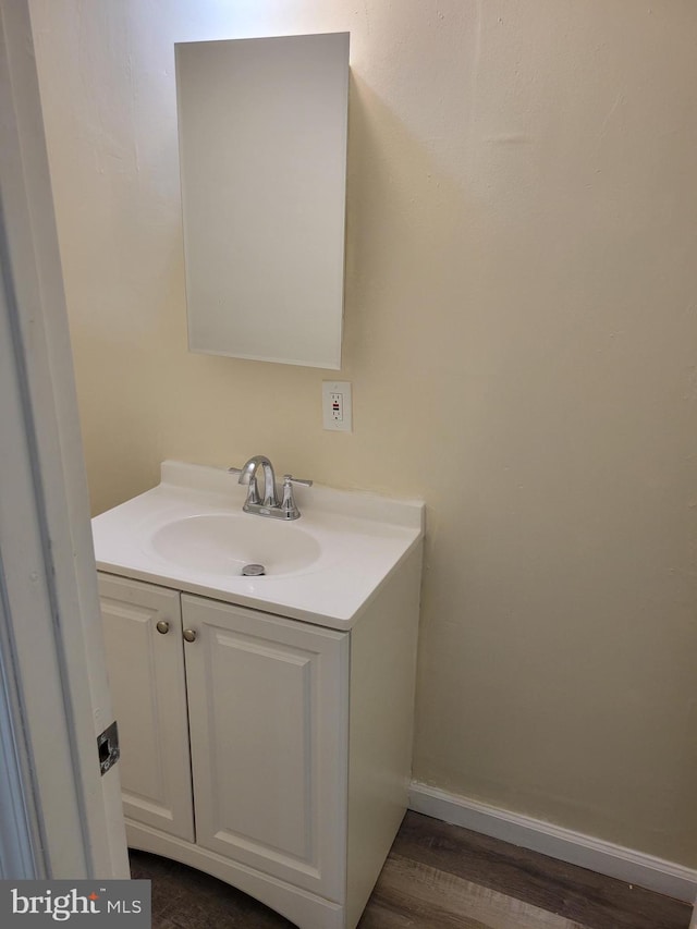 bathroom with vanity and wood-type flooring