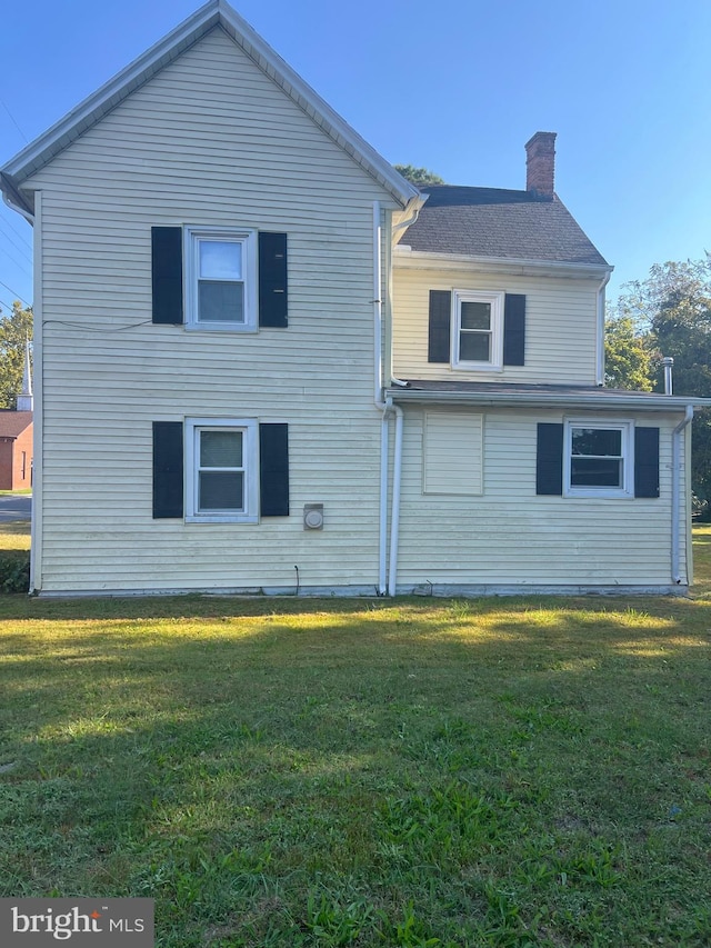 711 6th St, Pocomoke City, MD 21851 - back of house featuring a chimney and a yard