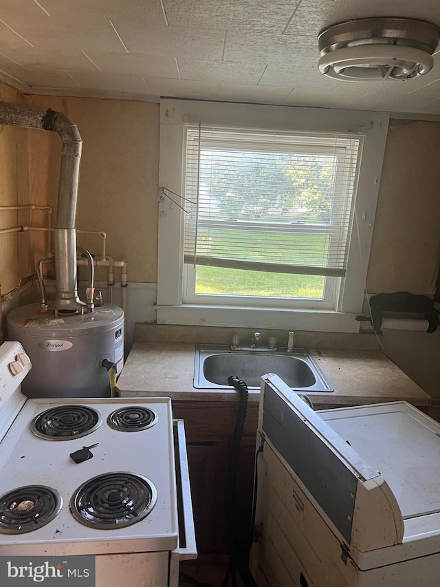 711 6th St, Pocomoke City, MD 21851 - kitchen featuring a sink, electric range, light countertops, and washer / clothes dryer