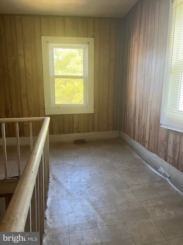 711 6th St, Pocomoke City, MD 21851 - spare room with wood walls and plenty of natural light