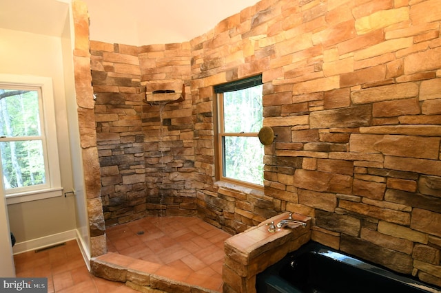 bathroom featuring independent shower and bath