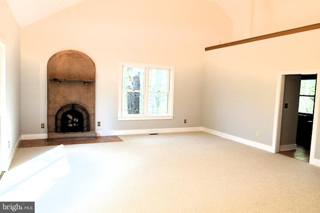 71 Fox Creek Ln, Woodville, VA 22749 - unfurnished living room featuring visible vents, high vaulted ceiling, carpet, and a fireplace with raised hearth